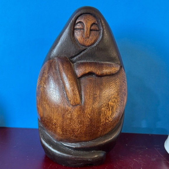 vintage Peruvian wood sculpture often depicting a nurturing mother